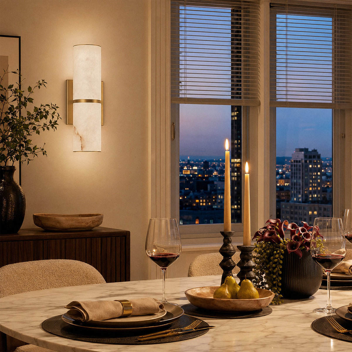 Spanish alabaster wall sconce glowing warm ambient light in elegant dining room with candlelit table setup