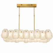 Spanish natural alabaster linear chandelier with brushed brass chain hanging on plain white background