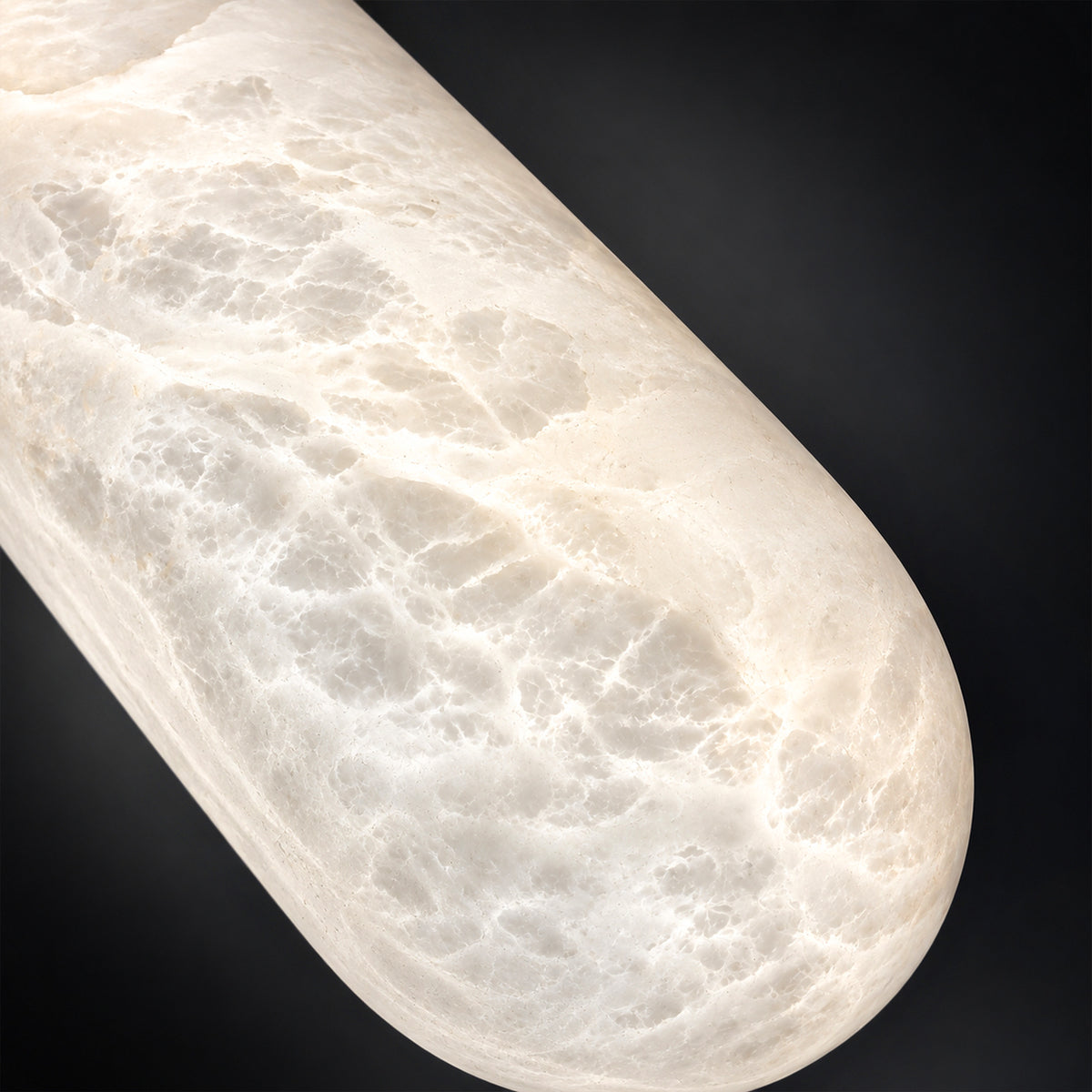 Close up view of translucent Spanish natural alabaster stone capsule light shade glowing with intricate organic cloud textures