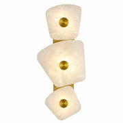 Organic shaped Spanish alabaster stone wall sconce with three tiered panels glowing on white background
