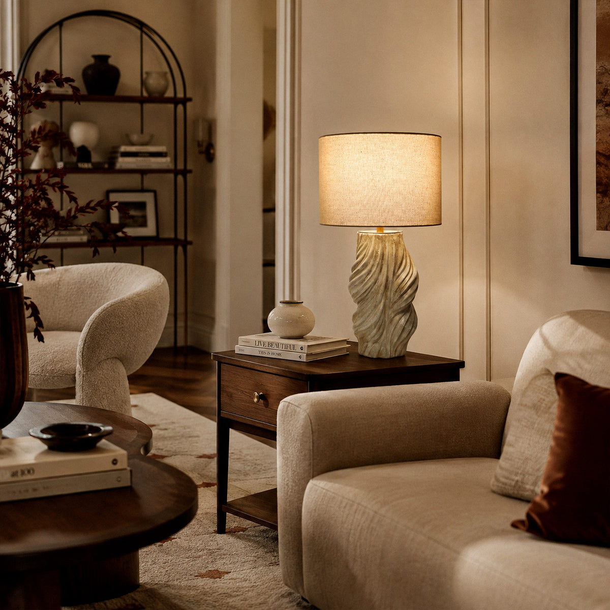 Handmade ceramic table lamp radiating warm light on side table near sofa in stylish living room