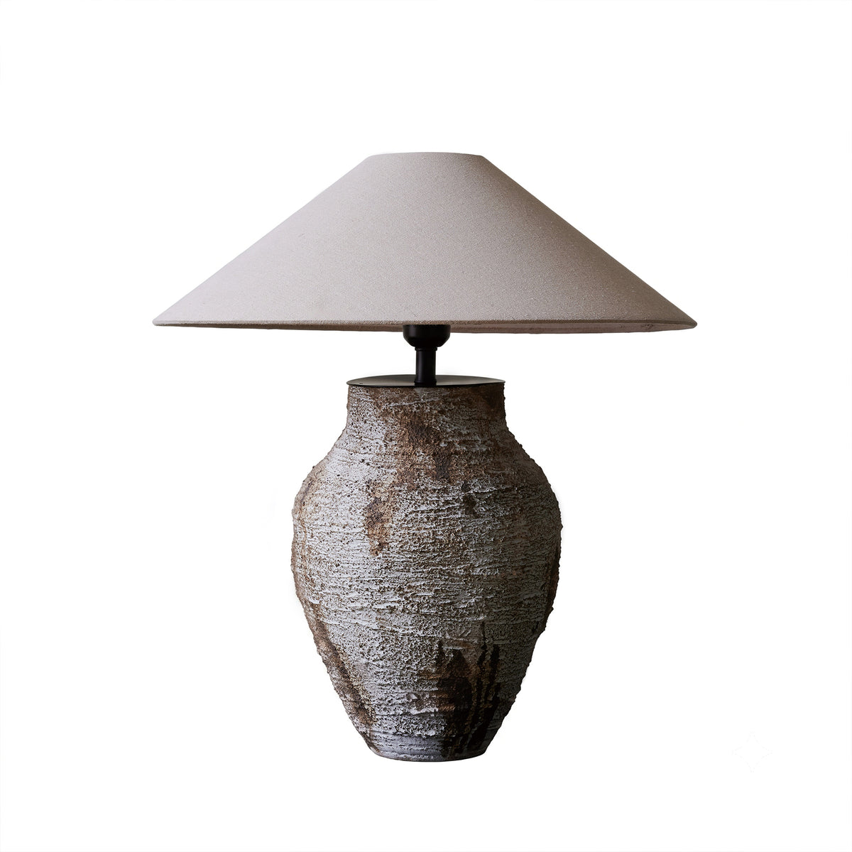 Artistic white rustic ceramic table lamp with conical shade on a plain background turned off.